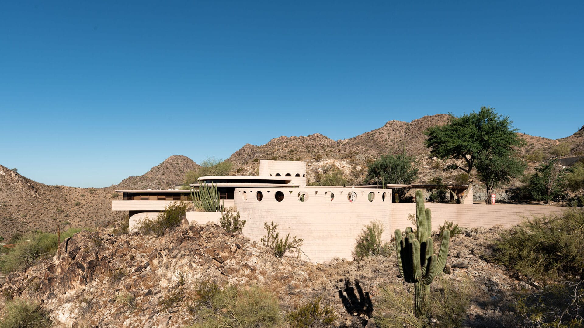 Frank Lloyd Wright’s Norman Lykes House in Phoenix, showing its curved concrete architecture and desert setting.