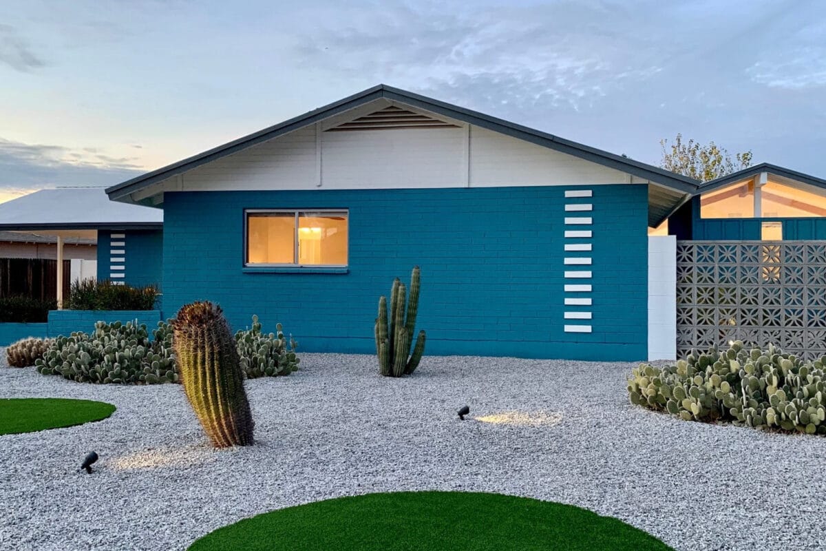 Mid-century modern home in Hy-View Scottsdale with blue exterior, breeze block, cactus landscaping, low roofline, and desert modern design.