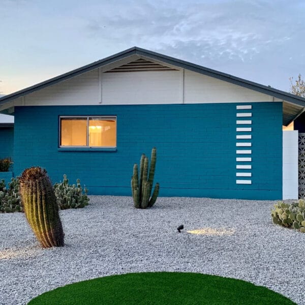 Mid-century modern home in Hy-View Scottsdale with blue exterior, breeze block, cactus landscaping, low roofline, and desert modern design.