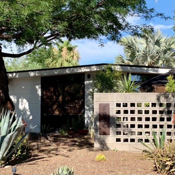 Ralph Haver mid-century modern home in Marlen Grove Phoenix with breeze block courtyard wall, low roofline, carport, agave landscaping, and mature trees.