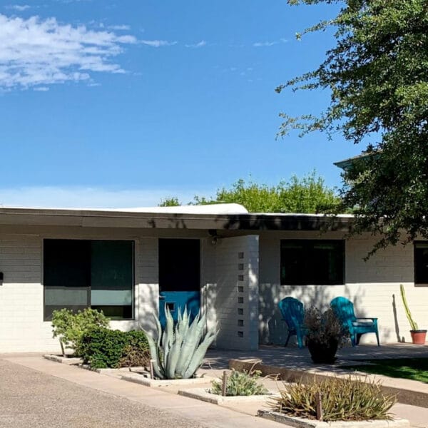 Ralph Haver mid-century modern home in Mayfair Manor Phoenix with blue front door, low roofline, garage, block wall, and desert landscaping.