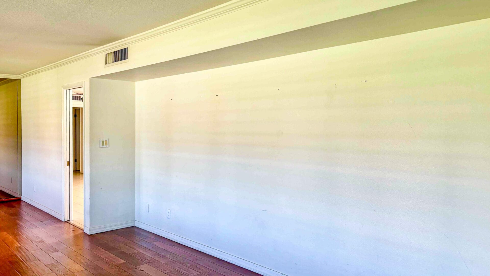 Original great room before renovation featuring low ceilings, enclosed wall layout, and separated living and kitchen spaces at Rose Lane residence in Phoenix, Arizona.