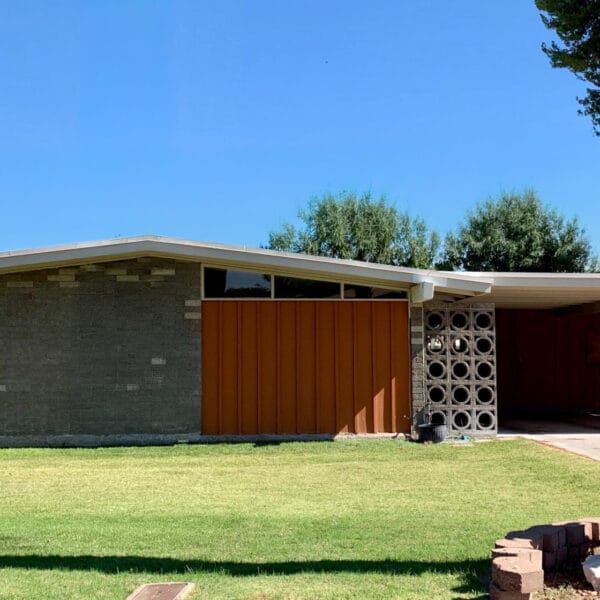 Ralph Haver mid-century modern home in Starlite Vista Phoenix with circle breeze block, low roofline, patio port, lawn, and palm tree.