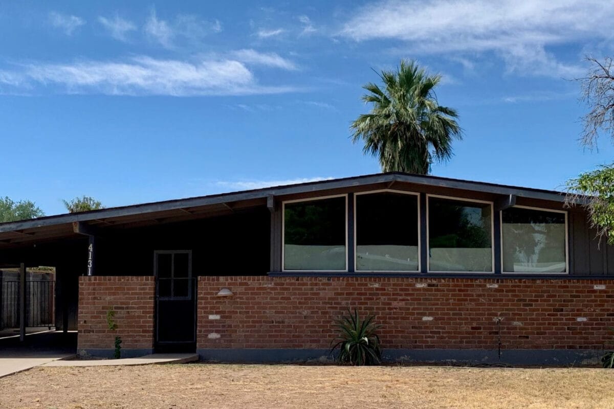 Ralph Haver mid-century modern home in Town and Country Manor Phoenix with brick facade, low roofline, clerestory windows, integrated carport, and desert landscaping.