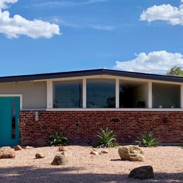 Ralph Haver mid-century modern home in Town and Country Scottsdale with clinker brick, turquoise front door, low roofline, clerestory windows, and desert landscaping.