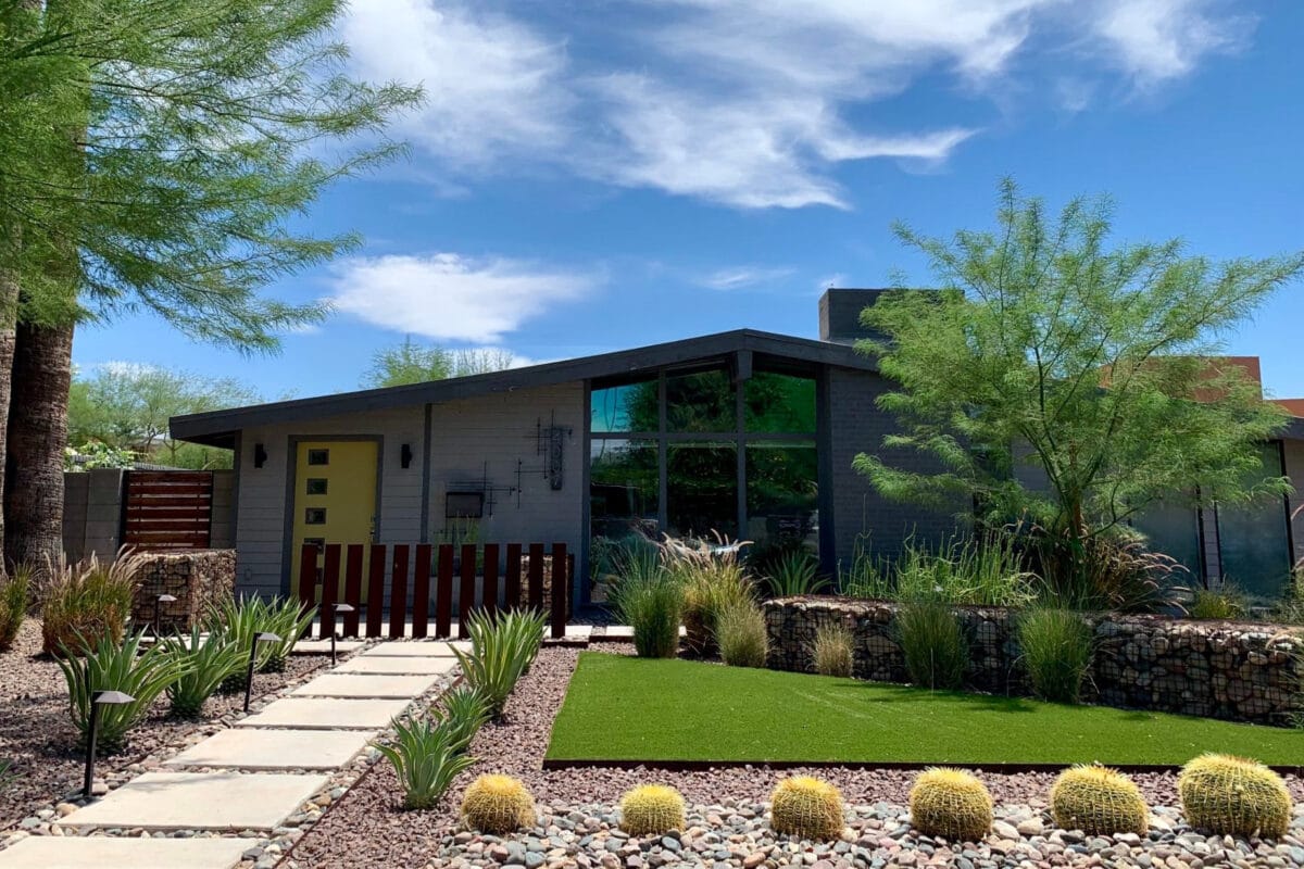 Ralph Haver mid-century modern home in Windemere Phoenix with yellow front door, low roofline, clerestory windows, and desert landscaping.